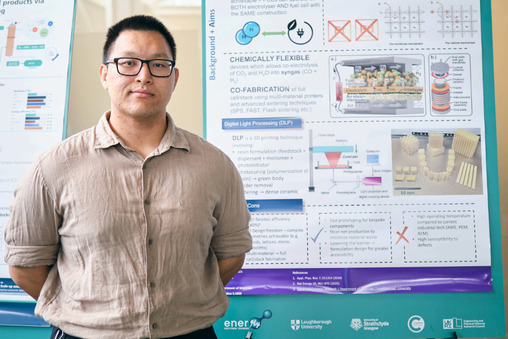 male researcher with academic poster in background